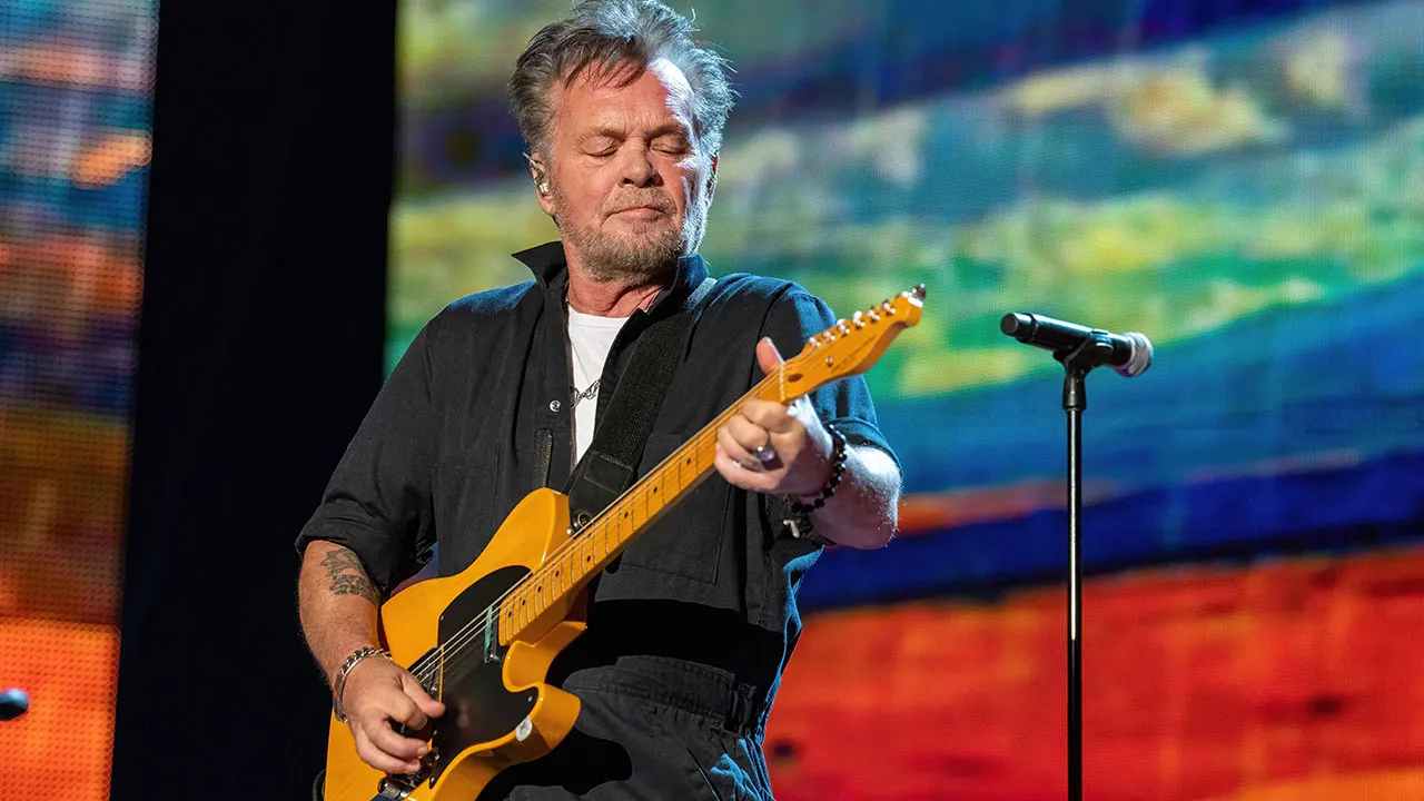 John Mellencamp Sits, Eats Popcorn During National Anthem – OutKick