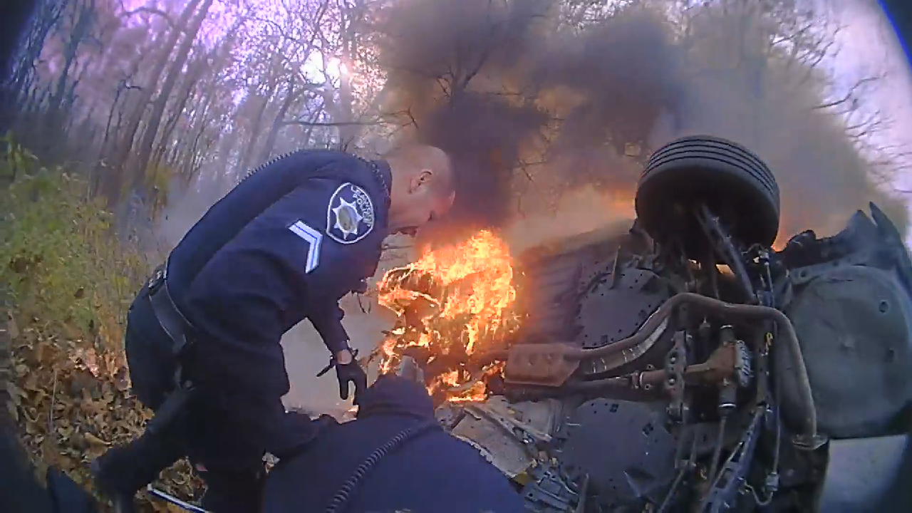 Video shows Kansas first responders pulling woman out of burning car