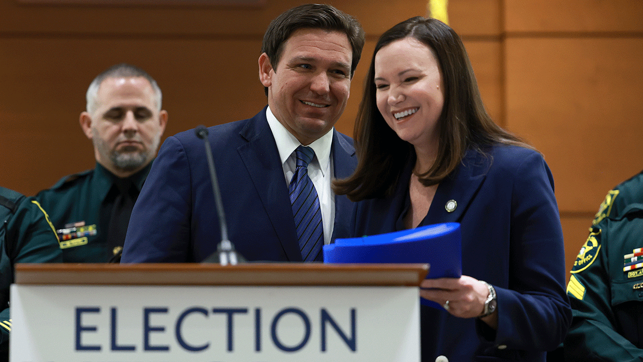 Florida AG Ashley Moody and Gov.  Ron DeSantis at public event. 