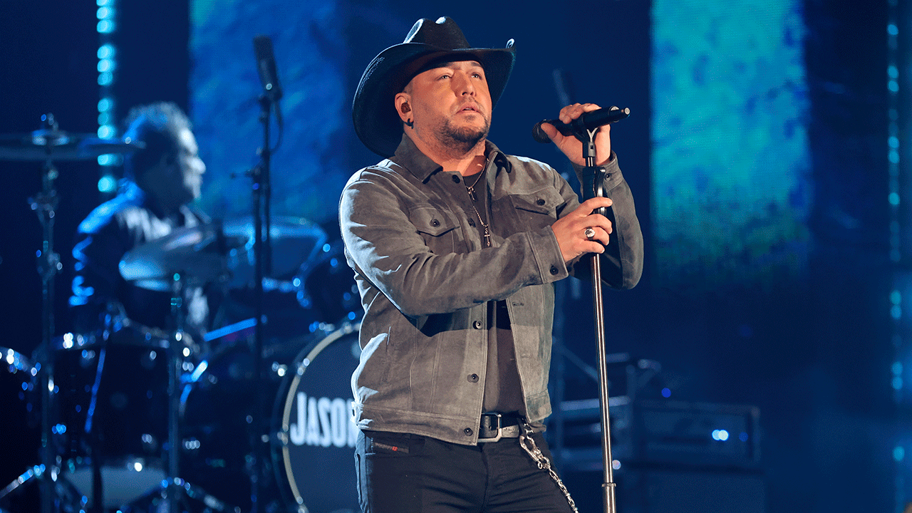 Jason Aldean performing on stage at the iHeartRadio Music Awards