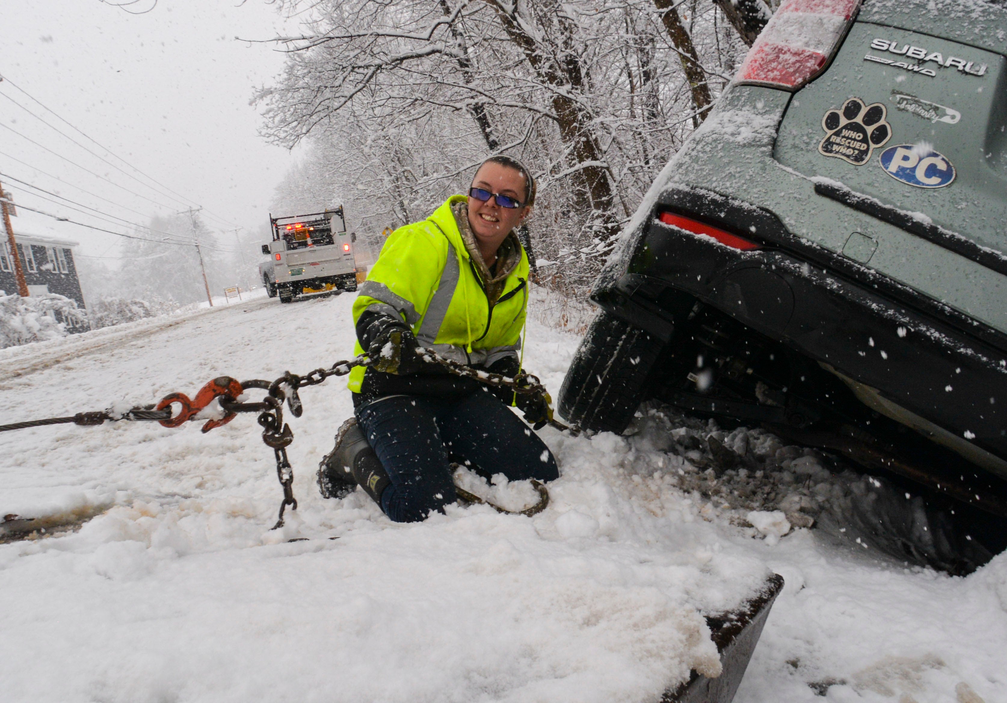 Brianna Brooks, owner of Scott Brooks Towing out of Townshend, Vermont, hooks up a vehicle to a flatbed truck at a three-vehicle crash site during a snowstorm on Friday, Dec. 16, 2022. (Kristopher Radder/The Brattleboro Reformer via AP)
