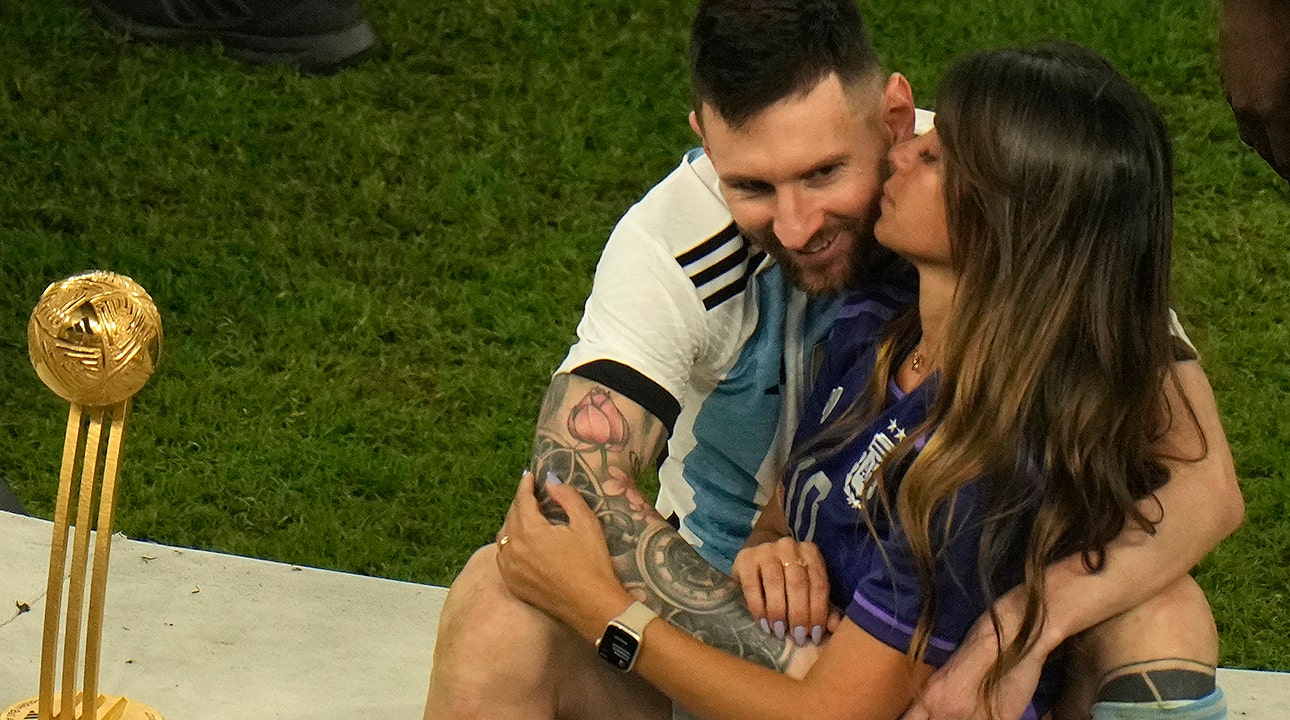 Lionel Messi Kisses His Trophy While Celebrating Win at FIFA World