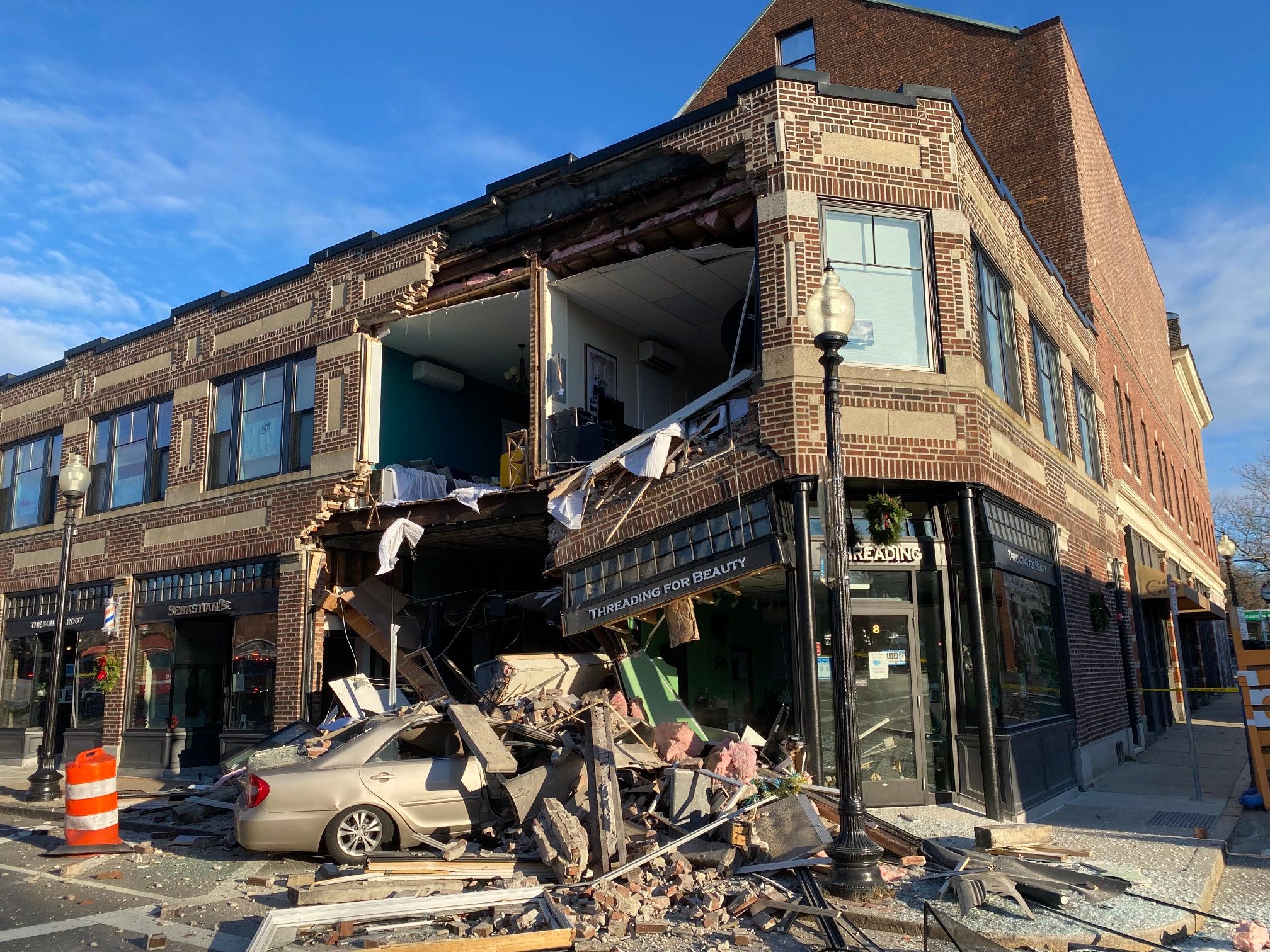 Massachusetts building's facade crumbles after car crashes into it