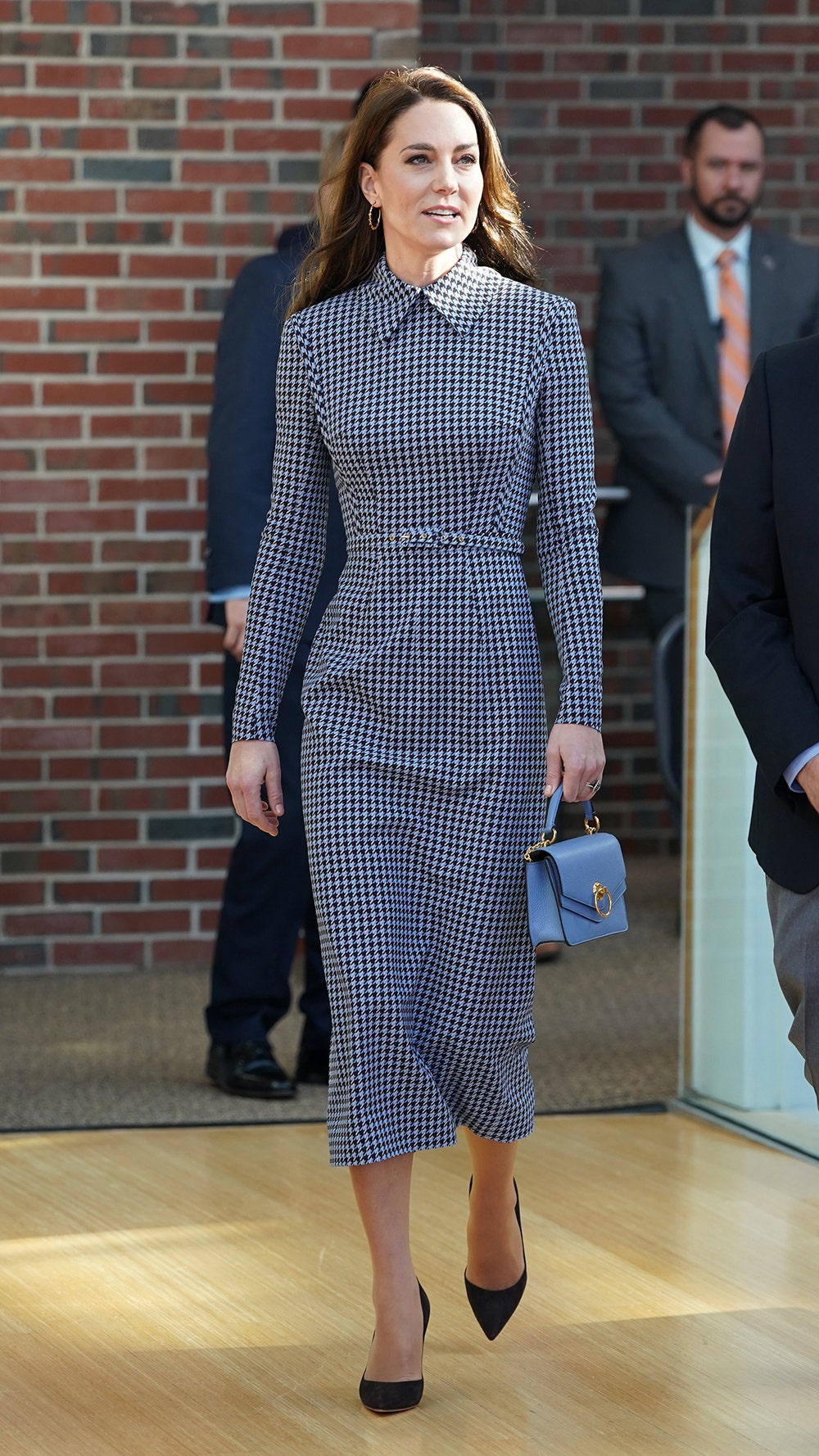 Kate Middleton holding her purse while visiting Harvard University