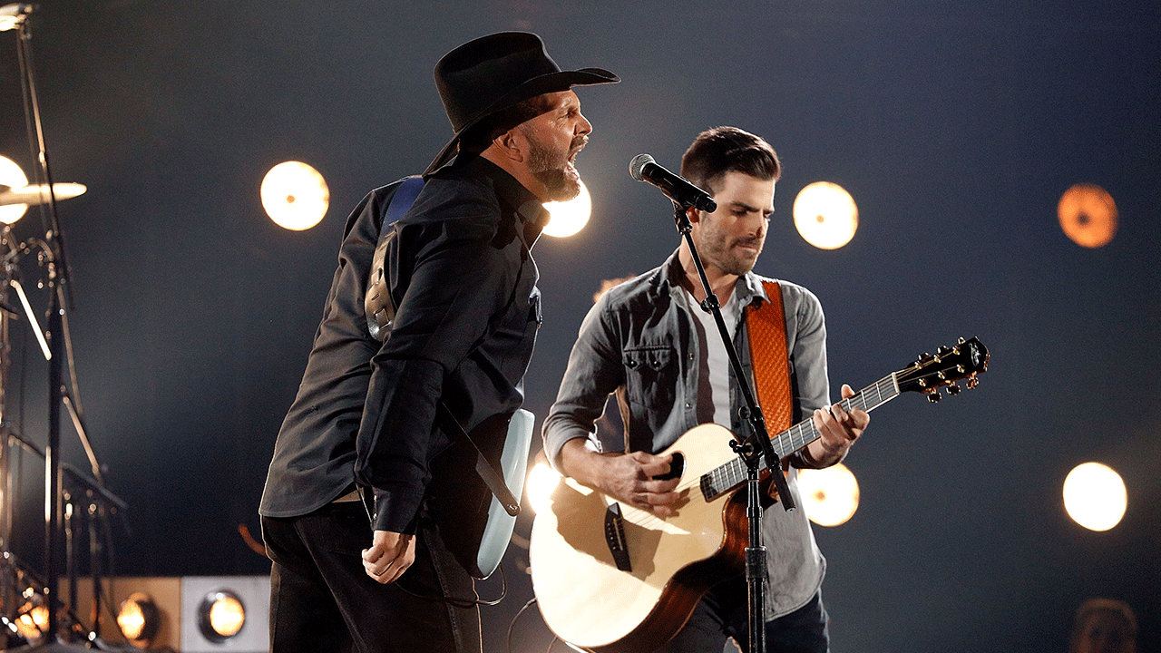 Garth Brooks and Mitch Rossell on stage