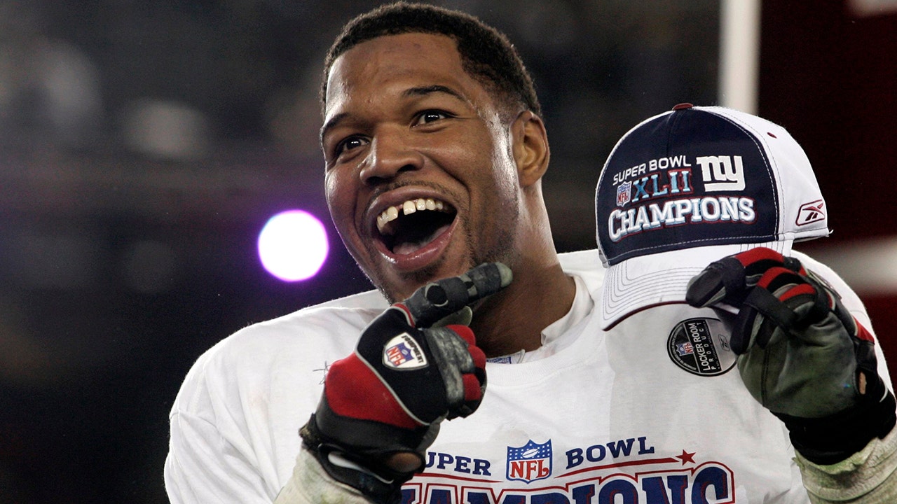 Giants Michael Strahan celebrates after the Giants win the Super