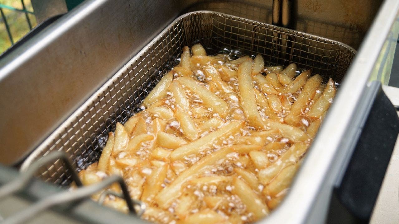 French fries being fried in boiling oil