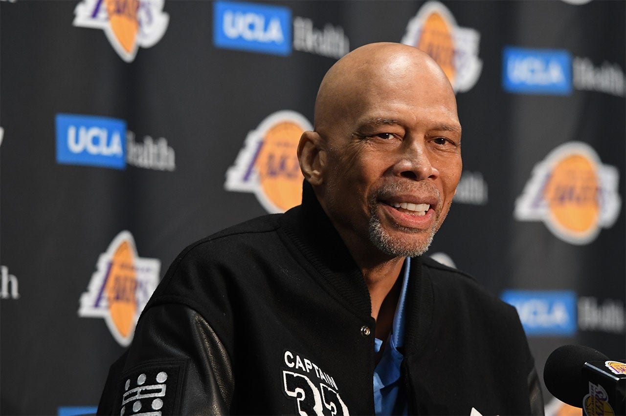 Kareem Abdul Jabbar and Magic Johnson of the Los Angeles Lakers sit News  Photo - Getty Images