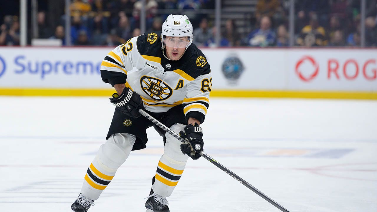 NHL referee takes out Bruins' Brad Marchand with surprise check in ...