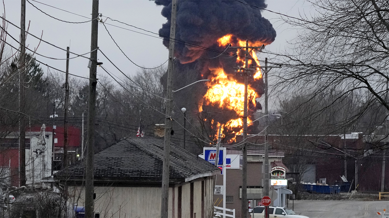 Ohio skyline lit up by fireball, black plumes of smoke as toxic chemicals are released from derailed train