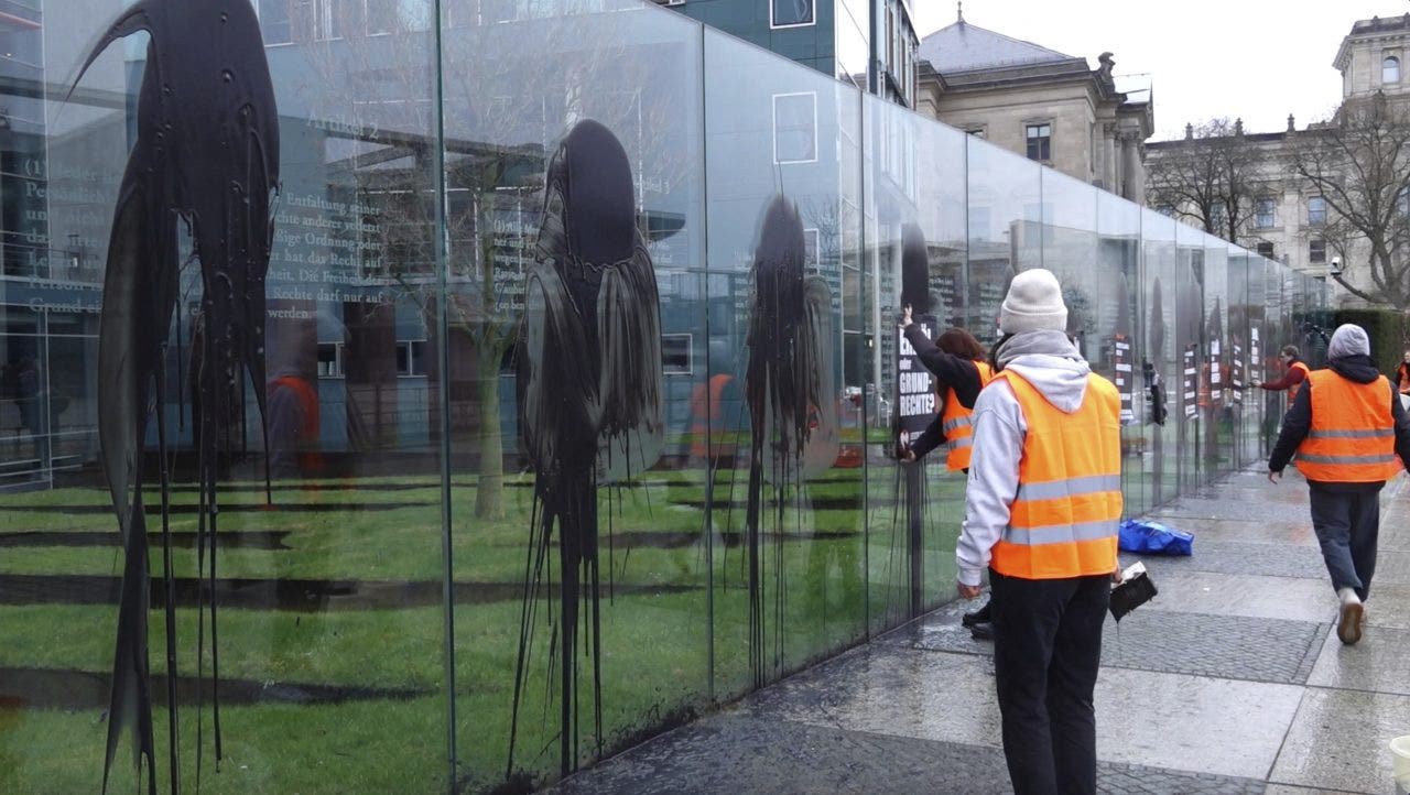 Climate activists deface constitutional monument in Germany with black paint, posters