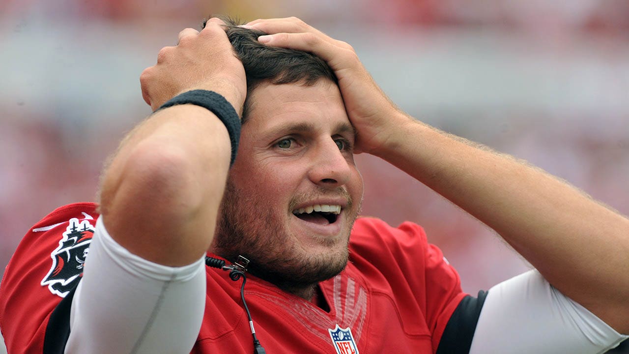 Detroit Lions quarterback Dan Orlovsky, right, sitting next to