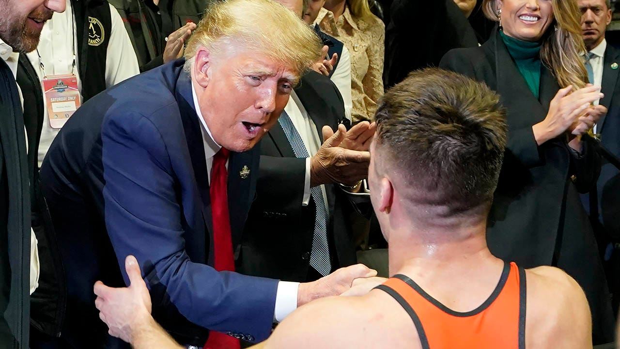Trump greets NCAA champion wrestlers, takes pictures with fans during title matches