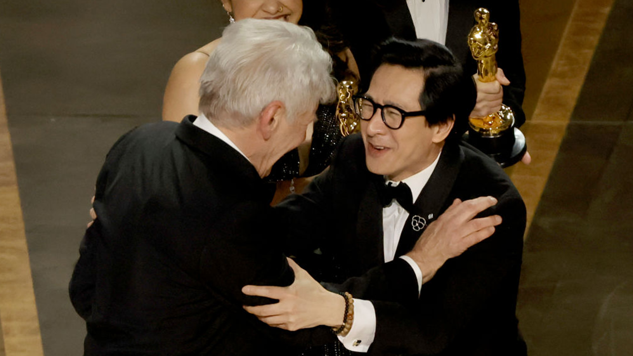 Ke Huy Quan embraced onstage by presenter Harrison Ford as ‘Everything Everywhere All At Once’ wins Oscar