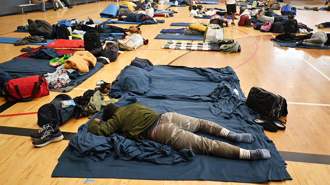 A migrant lie on the sleeping pad at a makeshift shelter in Denver, Colorado on Friday, January 13, 2023. 