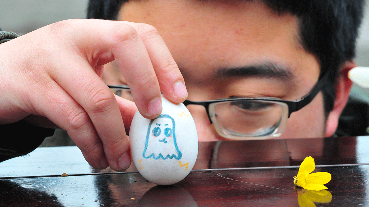 A person balancing an egg