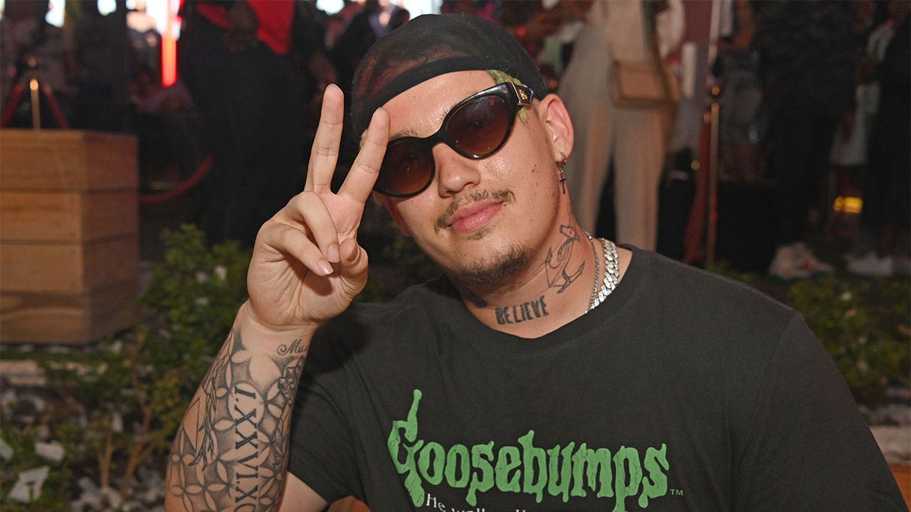 Rapper Costa Titch holding up a peace hand sign.
