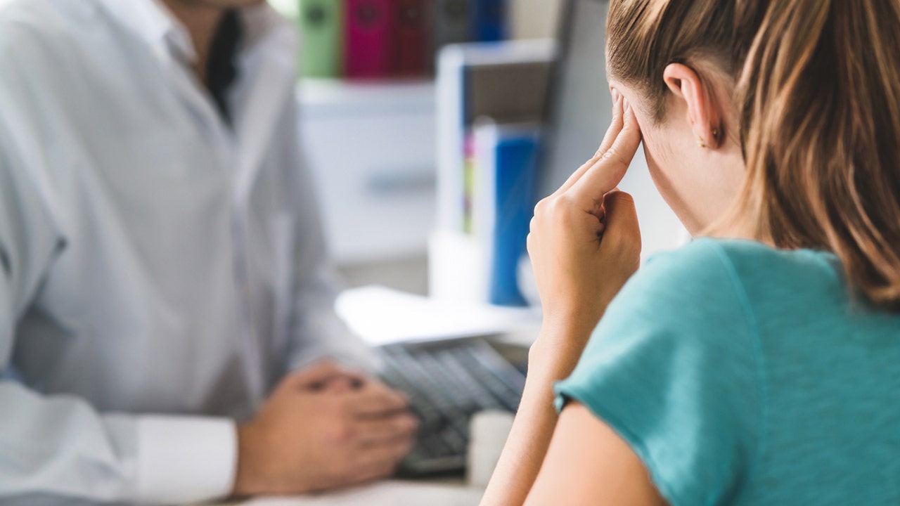 woman suffers from headache