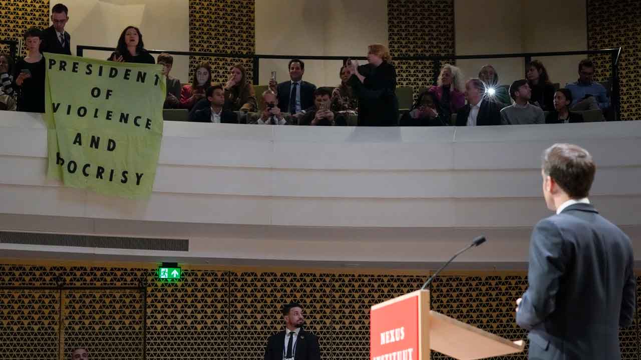 French pension reform protestors interrupt President Emmanuel Macrons speech in the Netherlands