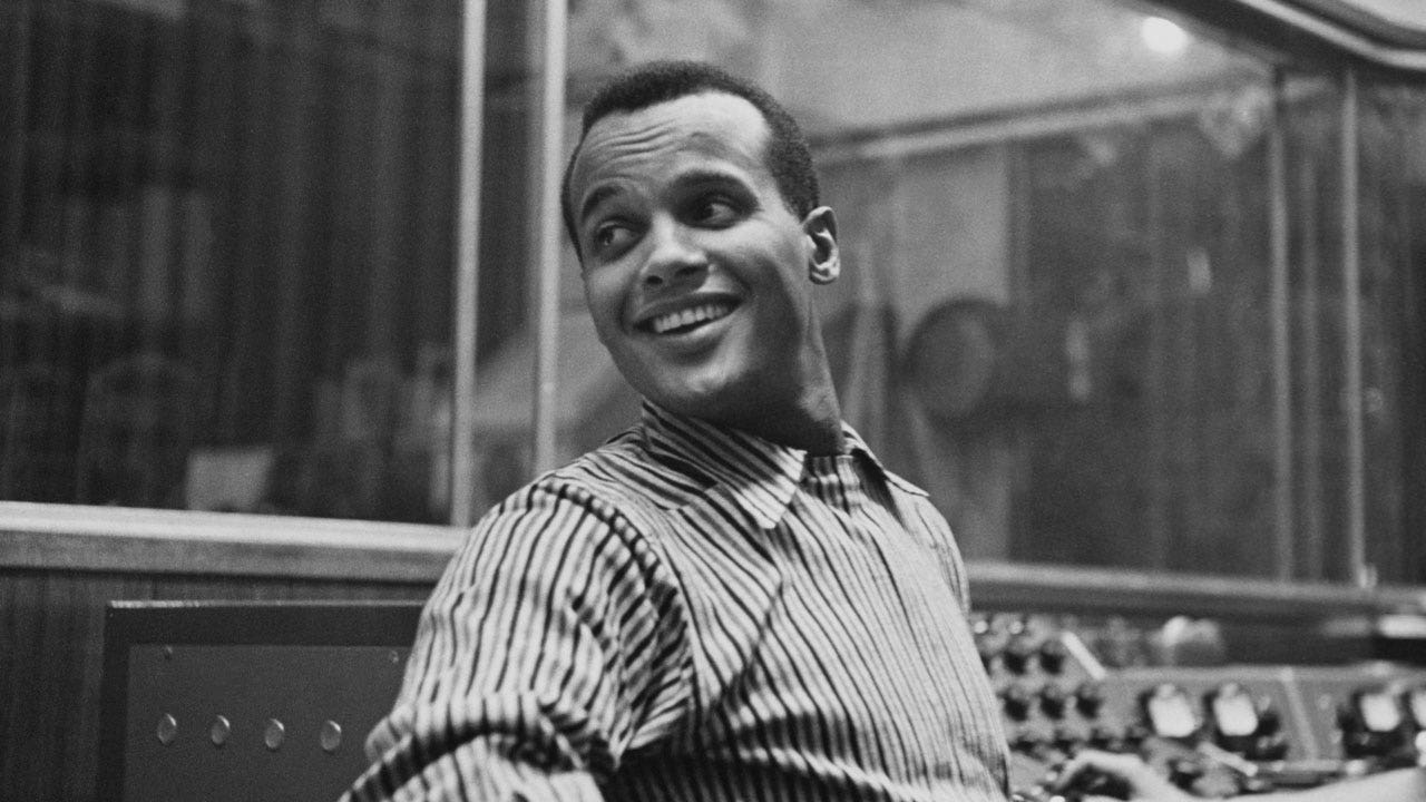 Harry Belafonte posing for the camera and looking over his shoulder