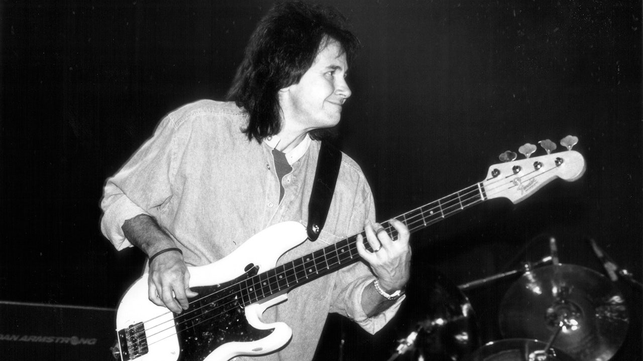 John Regan plays bass on stage at a concert