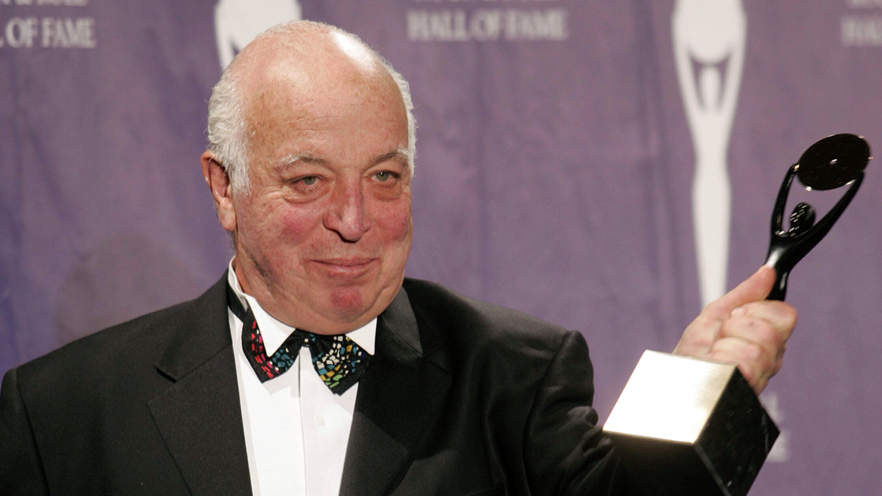 Seymour Stein holding his award after being inducted into the rock and roll hall of fame
