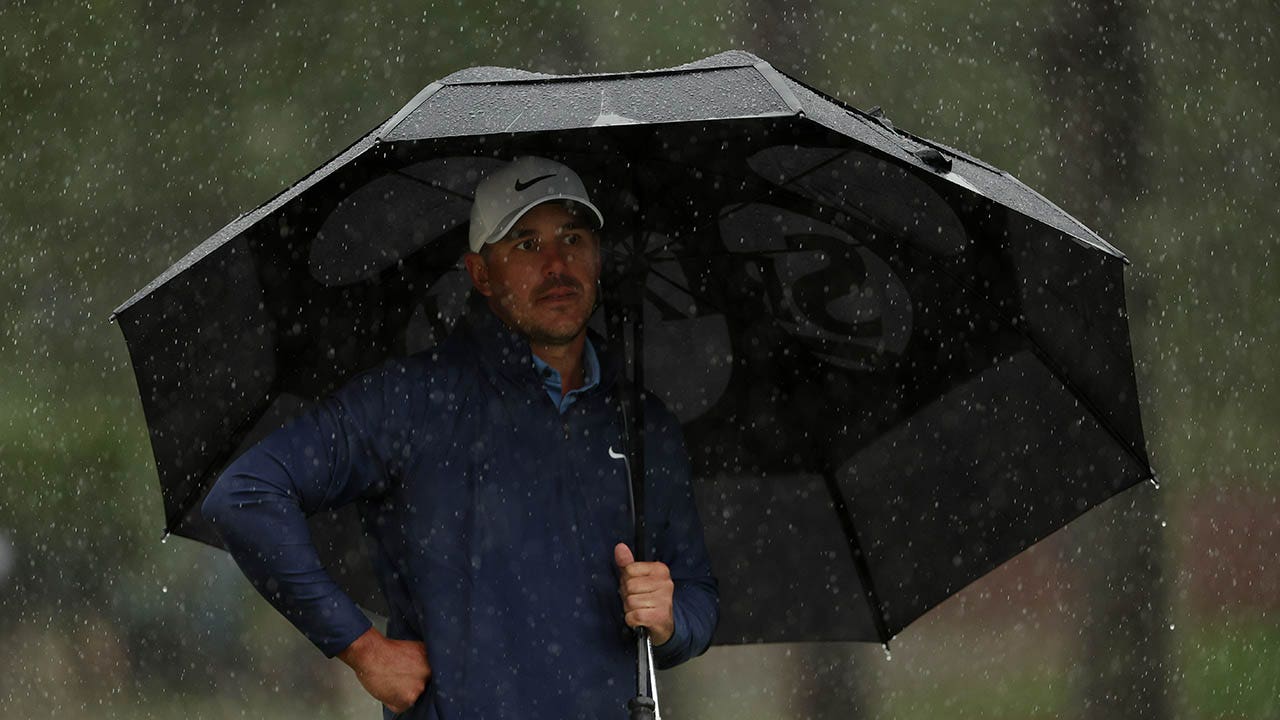 The Masters: Third round suspended as rain drenches field at