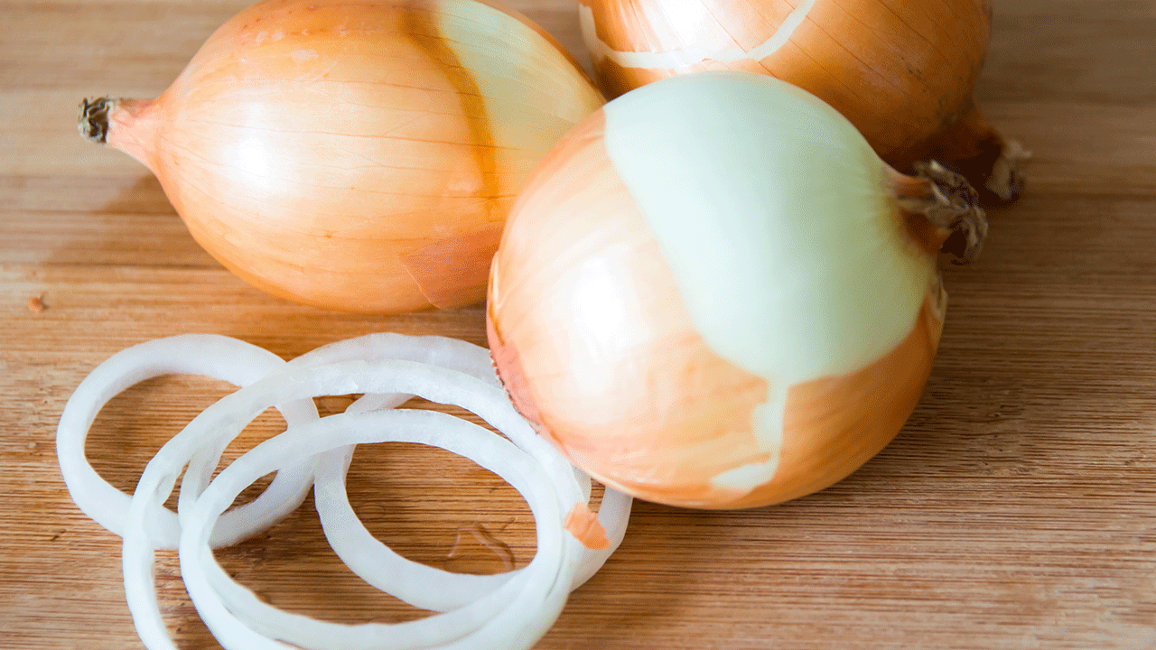 Yellow onions with the skin on them