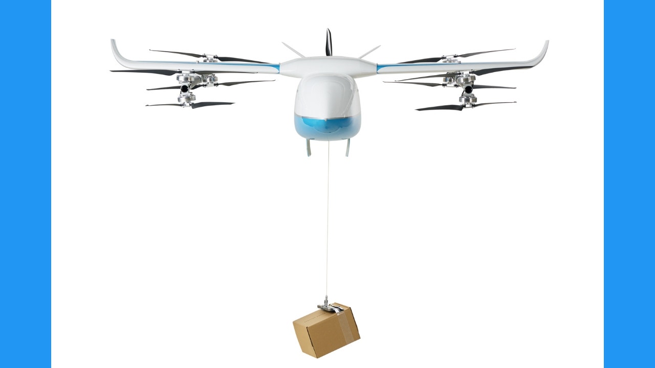 Drone carrying a box flying forward.