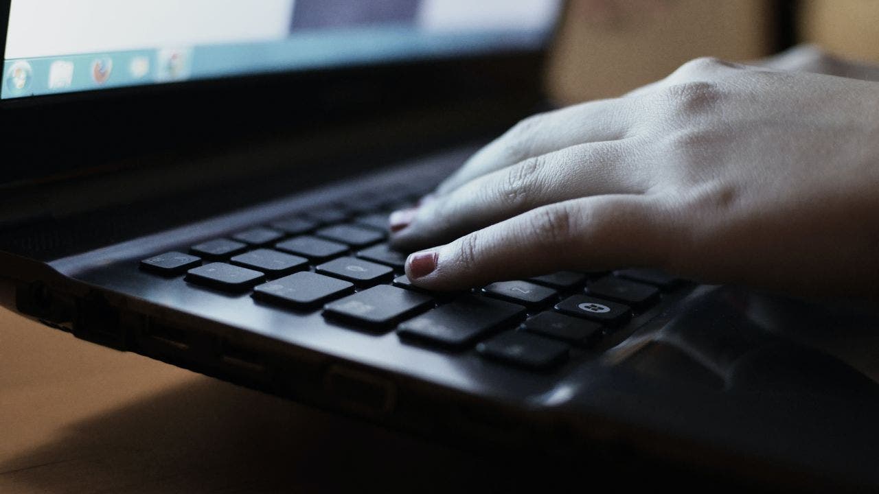 Woman typing on keyboard