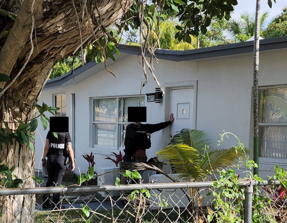 Police at the door of Sam's house.