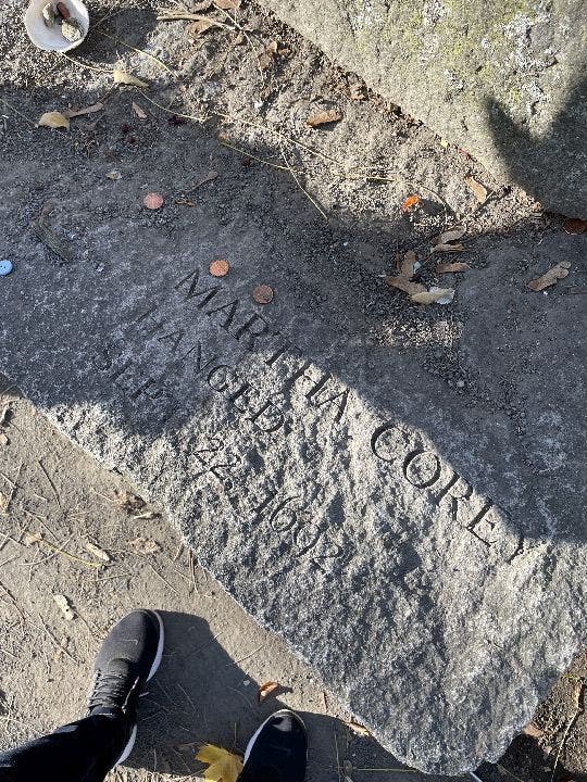 Martha Corey memorial stone with pennies