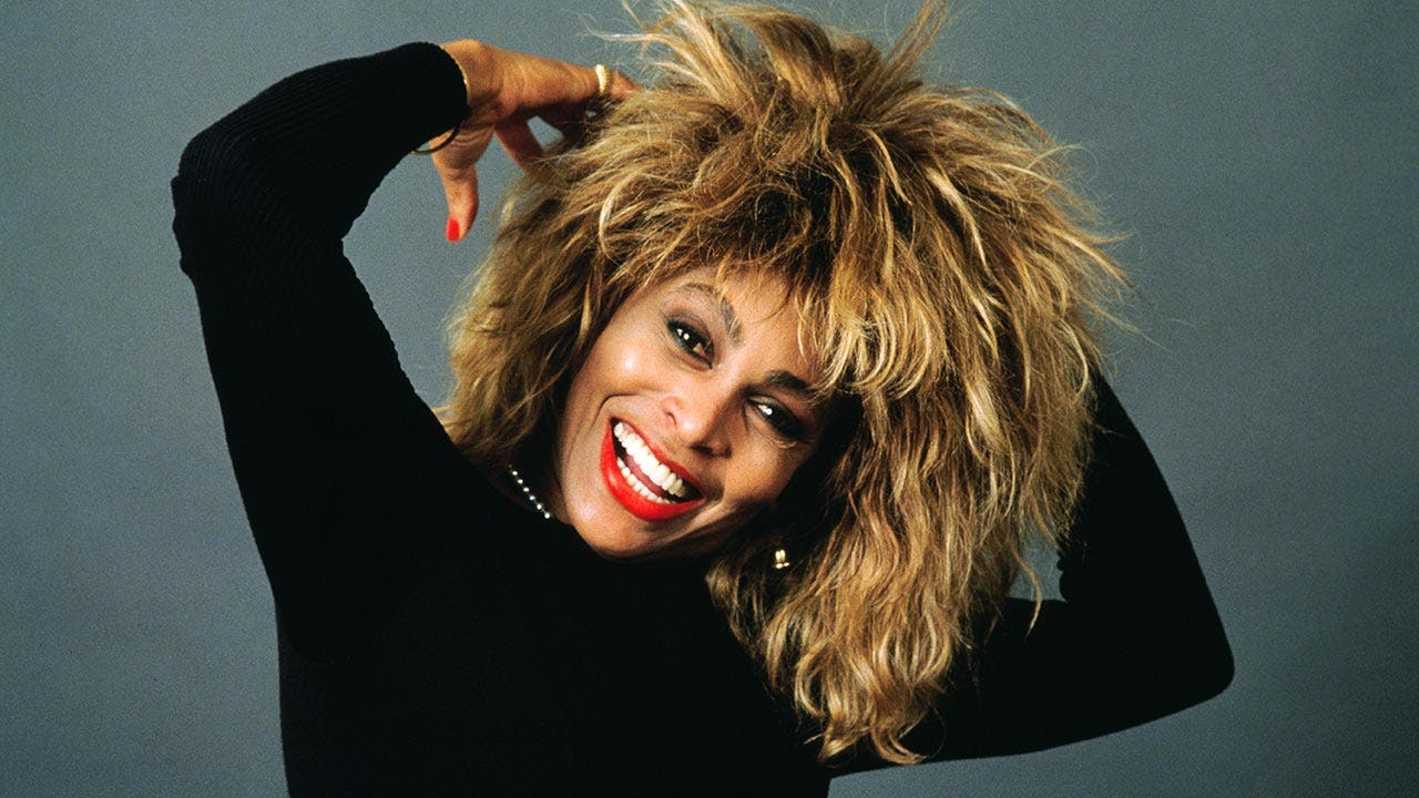 Tina Turner posing in a silly way for the camera