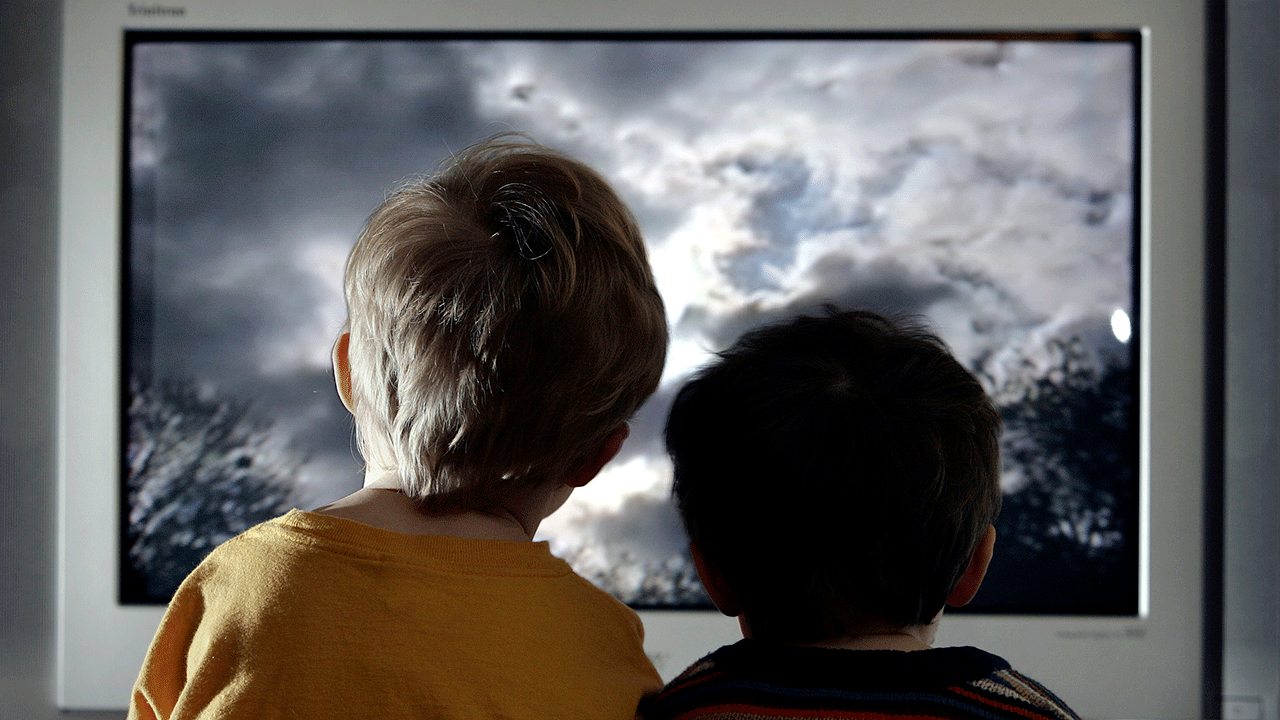 Two children watching TV
