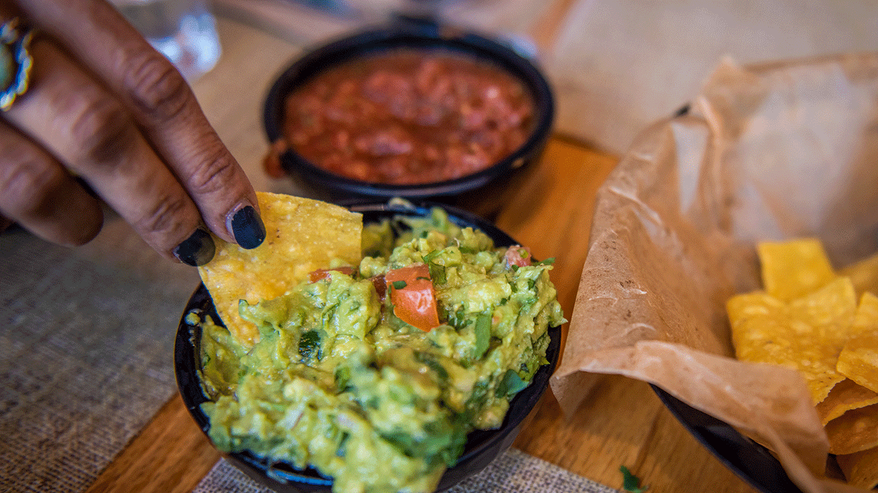 Chip being dipped in guacamole