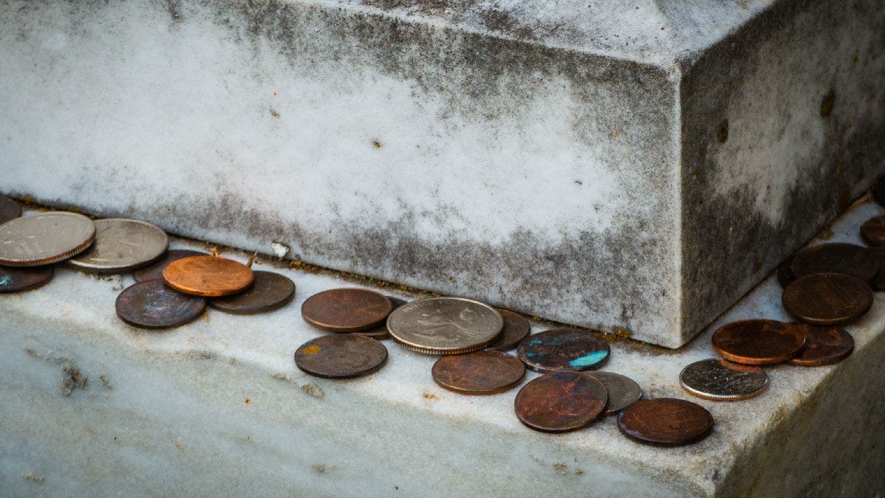 Coins left on gravestones: What does it mean and why do people do it?