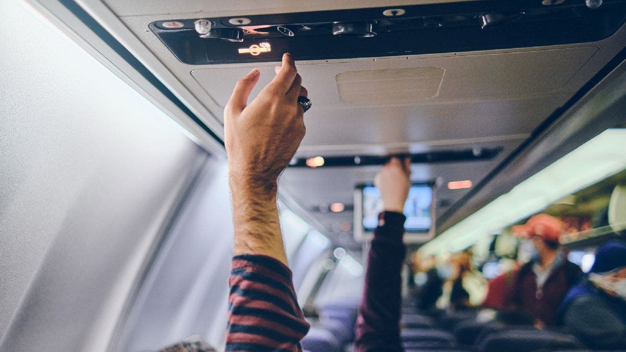 People adjust their airplane air conditioner settings.