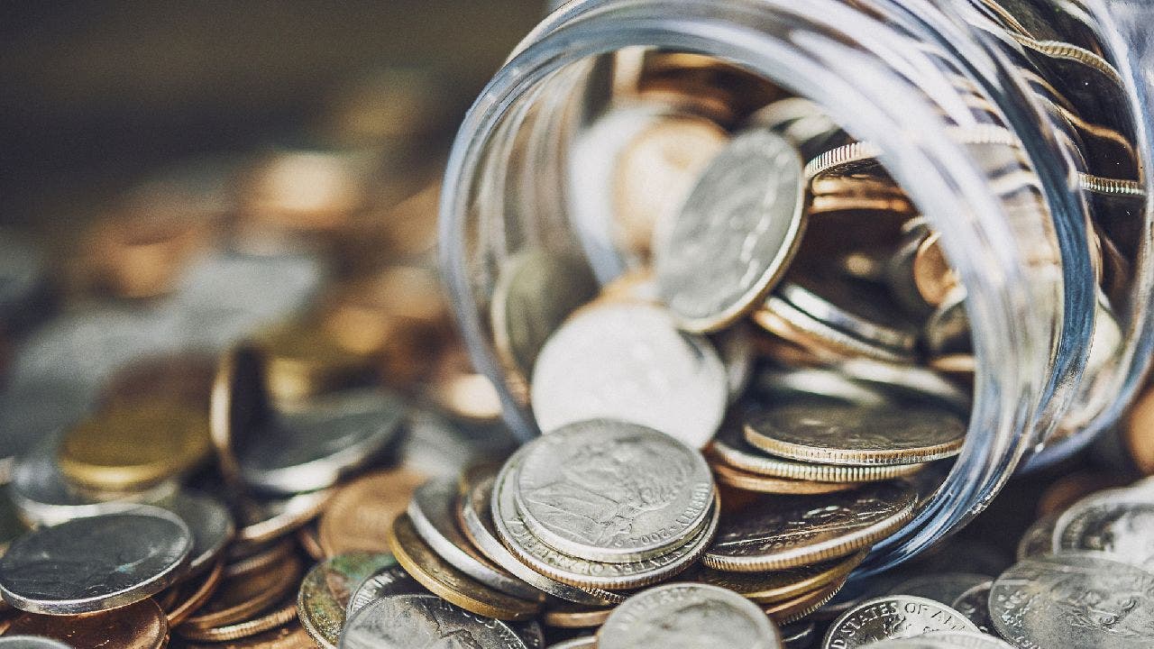 Glass jar filled with coins