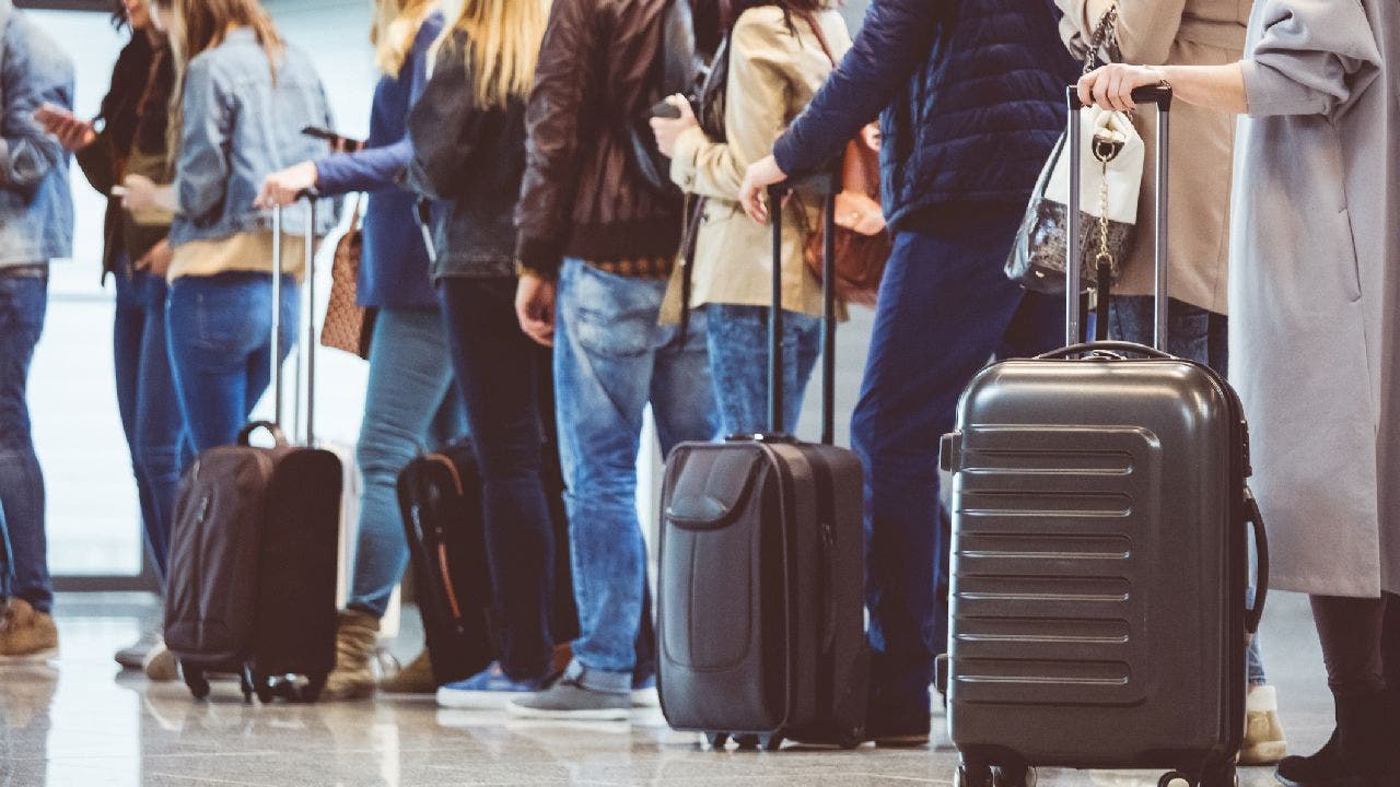 Passengers line up to get on plane