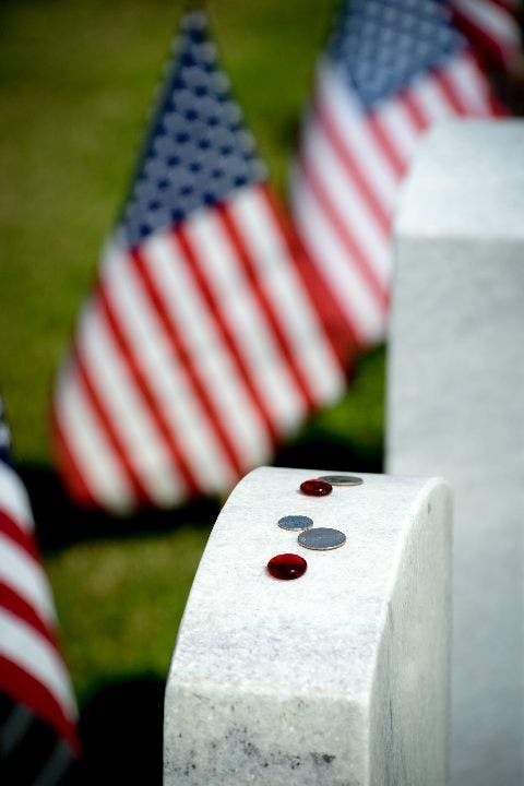 Coins on veteran gravestone