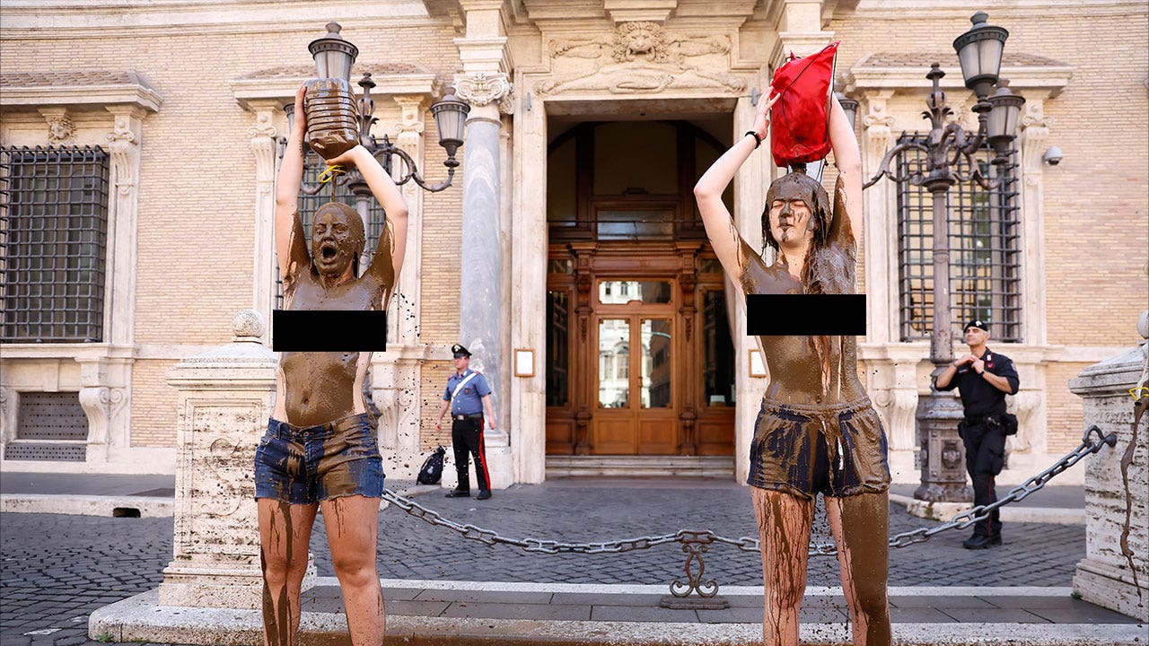 Bare-chested climate activists in Rome smear themselves with mud to protest fossil fuel use, evoke flooding