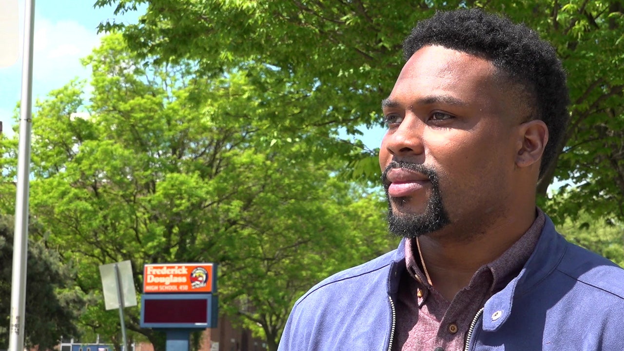 Jovani Patterson stands near Frederick Douglass High School in Baltimore, Maryland