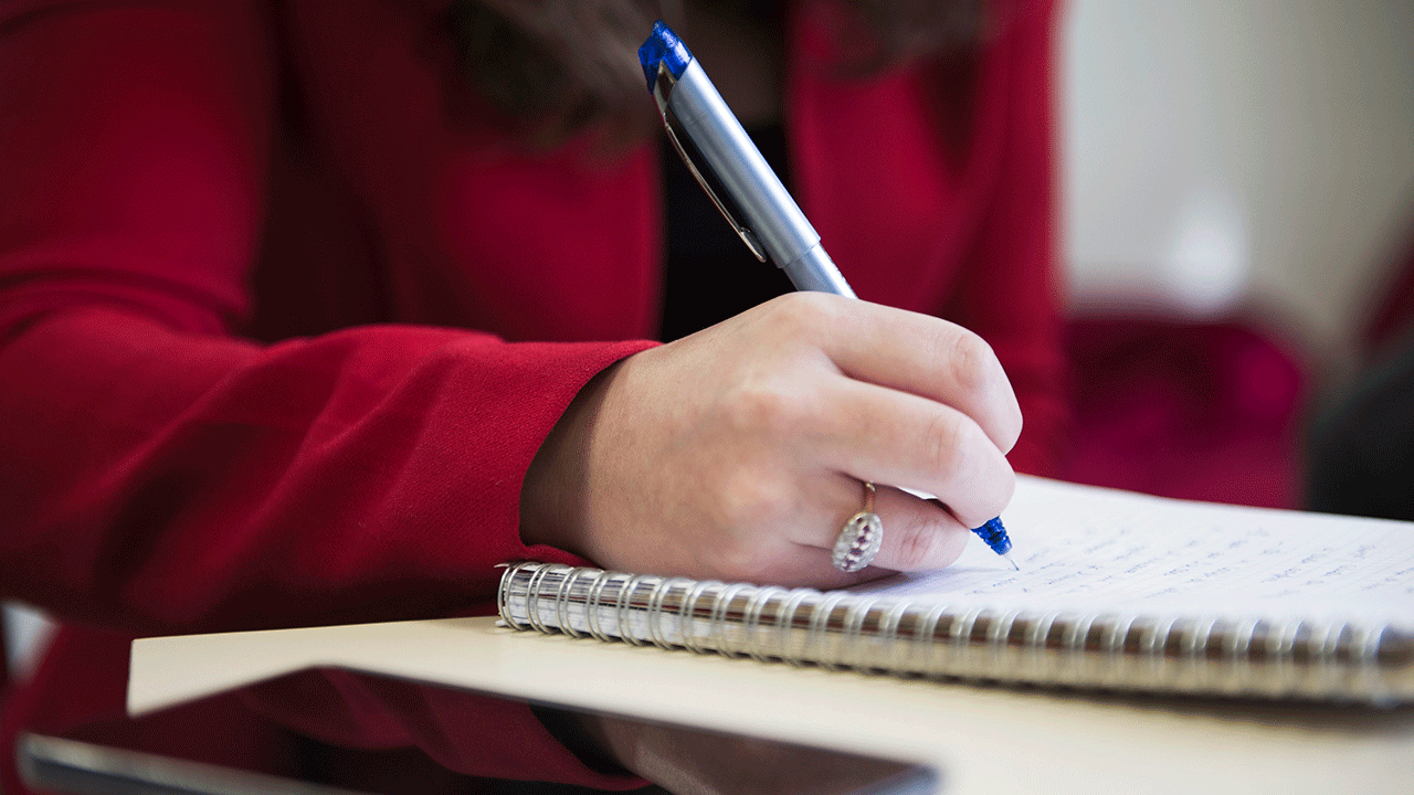 Person writing down notes