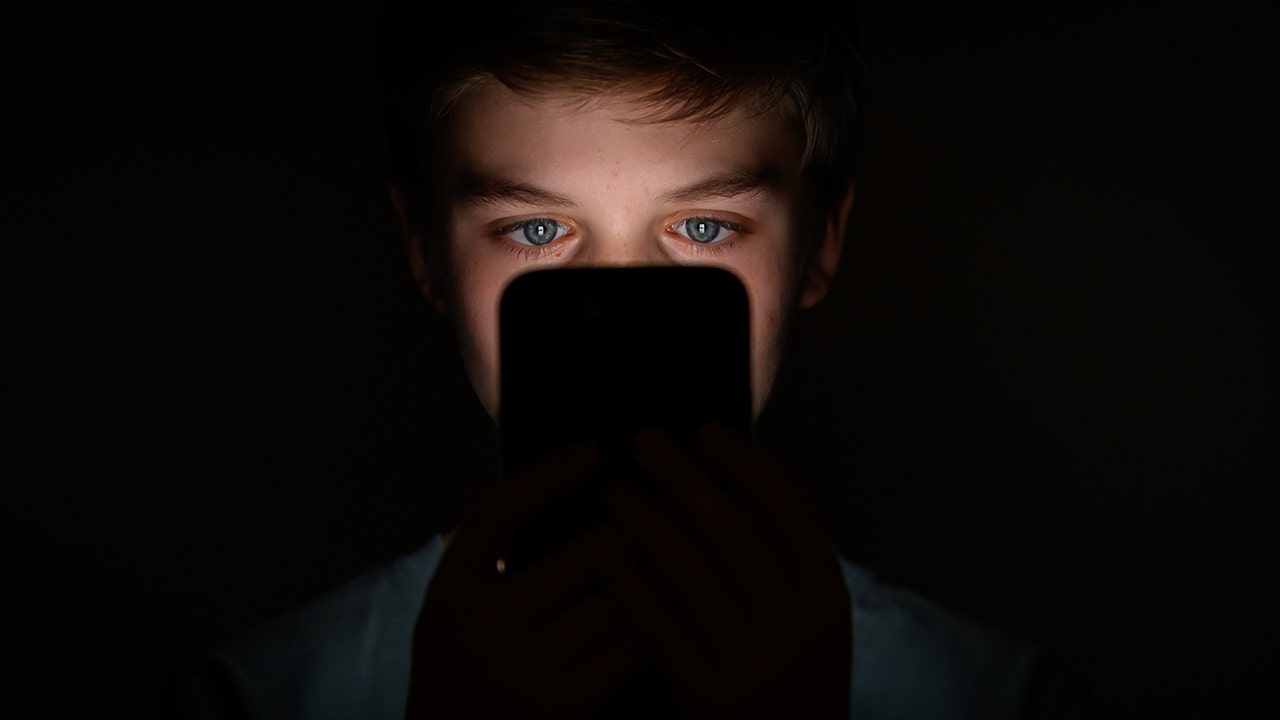 Boy looking at a phone