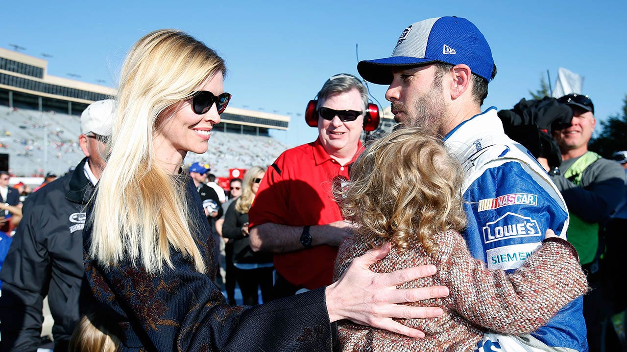 Jimmie Johnson and his family at a NASCAR race