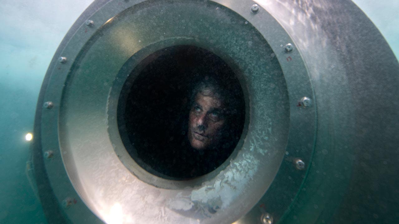 Haunting photos show late OceanGate CEO Stockton Rush test diving his Titan sub