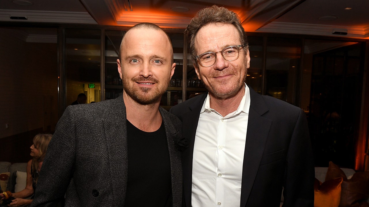 Aaron Paul and Bryan Cranston smile at a Breaking Bad event