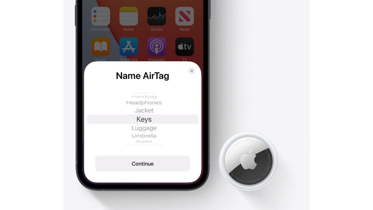 AirTag next to an iPhone with AirTag notification on screen