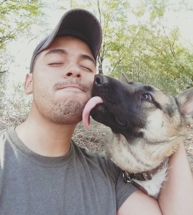 Kevin McKenna poses next to his dog