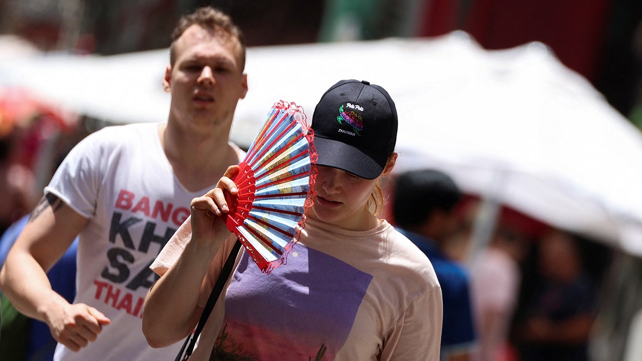 Woman fanning face during heat wave